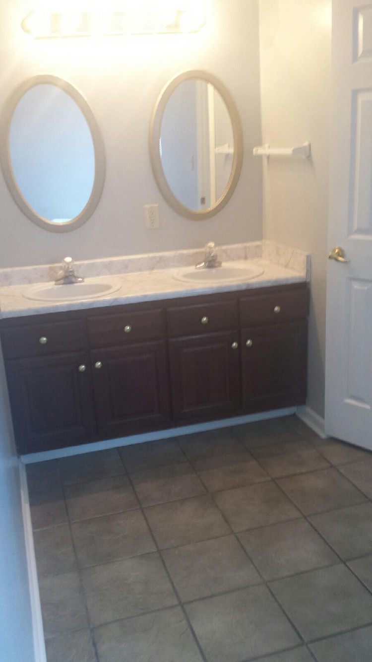master bath, double sinks and ceramic tile flooring