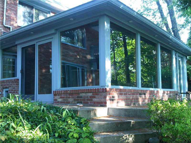 sun room is located on the lower level with panoramic views of paradise lake