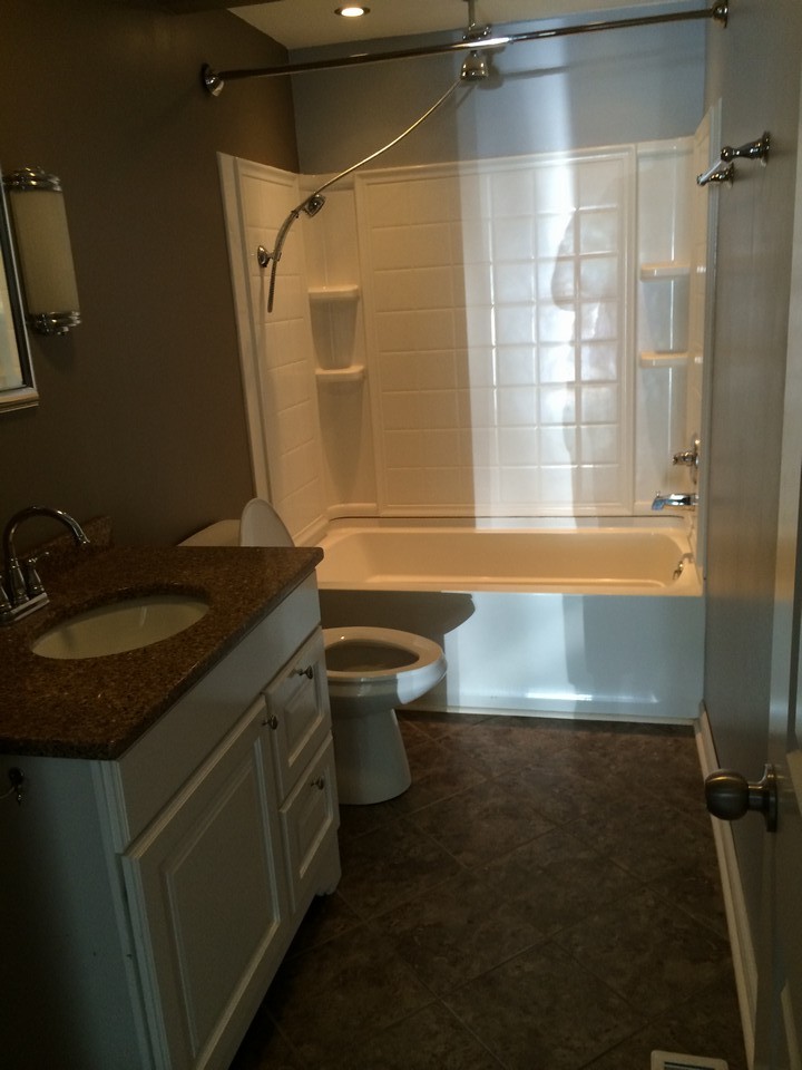 full bath, with granite counter top and tile floors