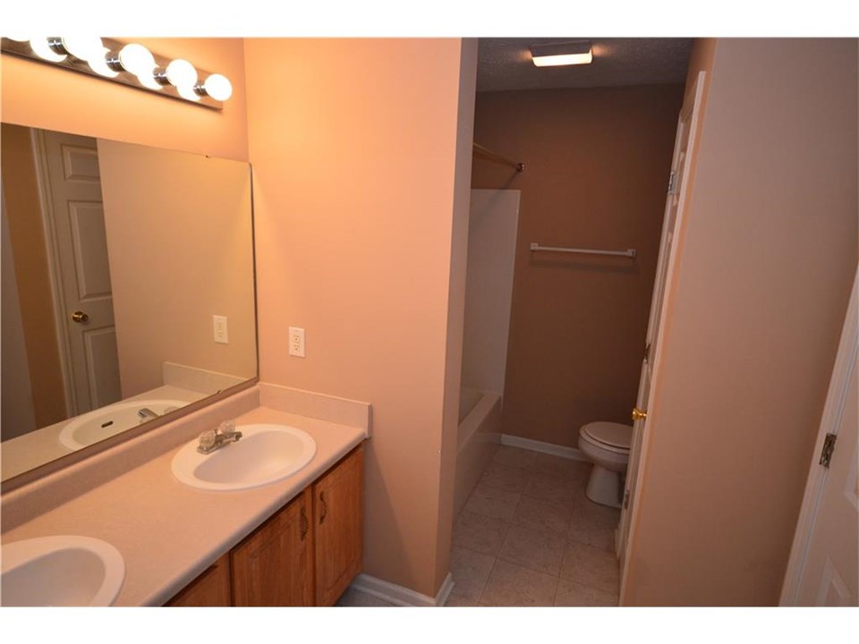 full bath with double sinks and opens to master bedroom or hall