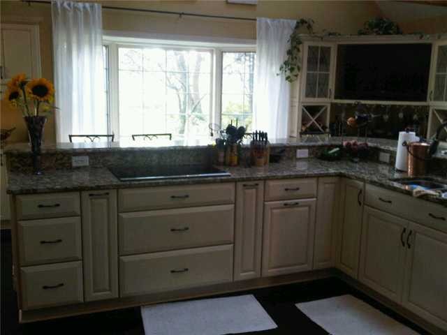huge wrap around island, induction cooktop, top end kraftmaid cabinets with softclose! 3 slabs of granite make up the countertops throughout this brand new kitchen